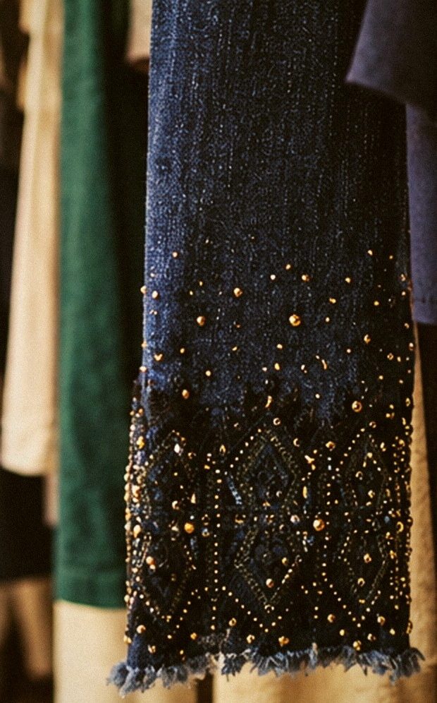Close-up of a navy sleeve with gold beading